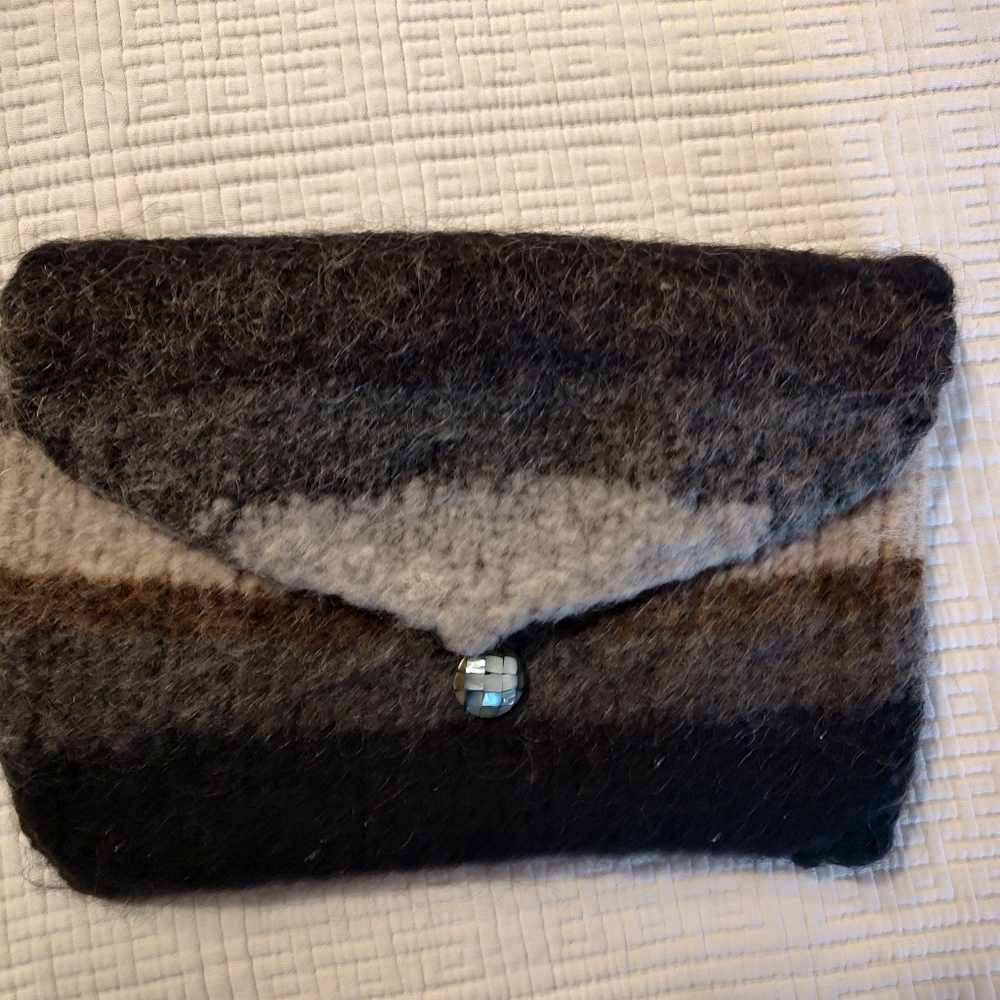 Hand felted clutch purse with large belt loops. Rarely worn.
